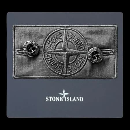 Front view of shadow project badge with compass design